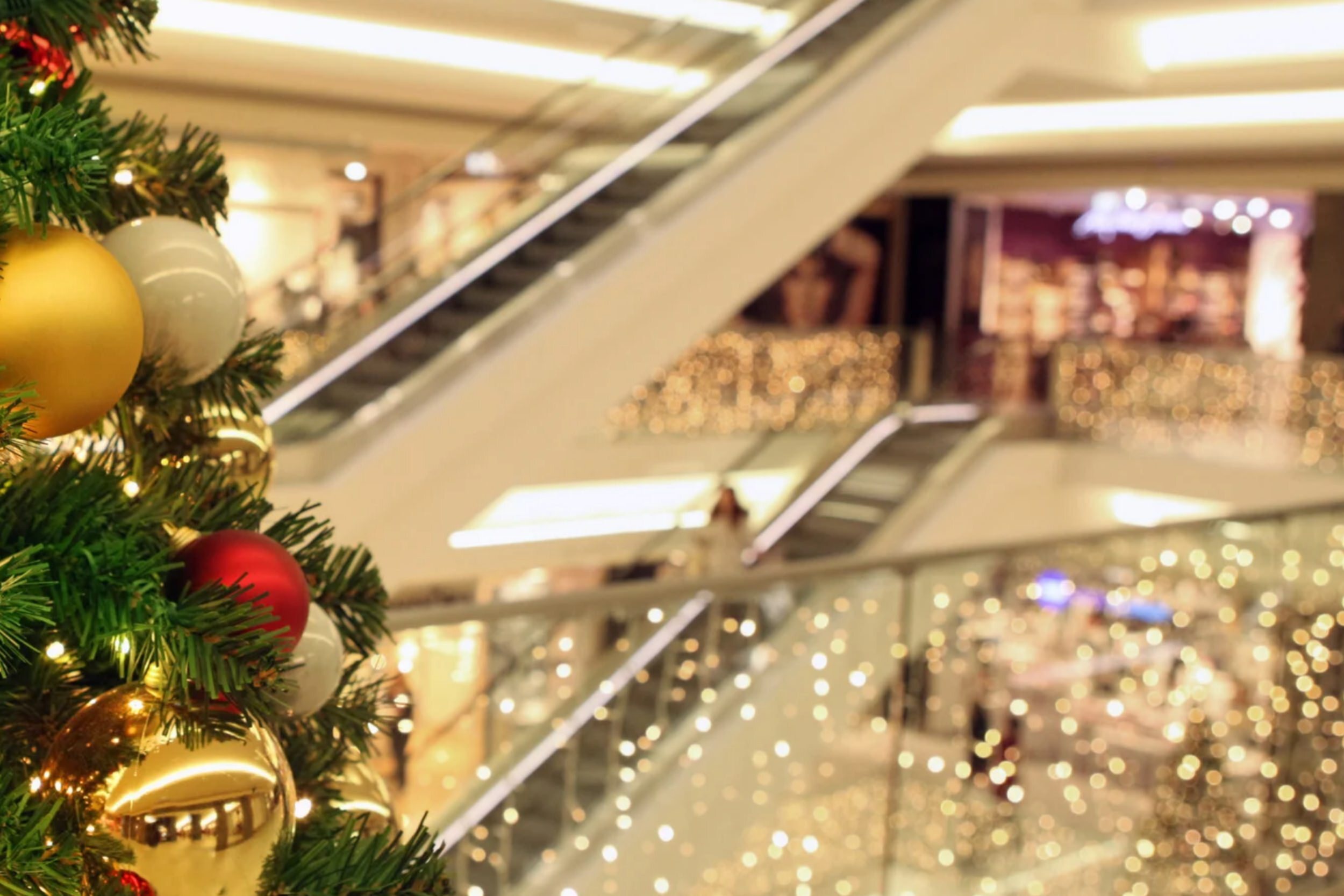 Holiday decorations and lights in front of an escalator