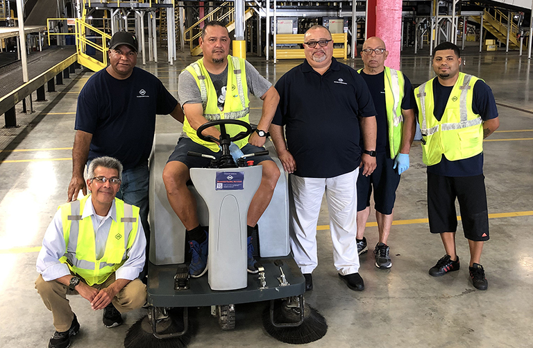 KBS crew members in a warehouse facility they manage