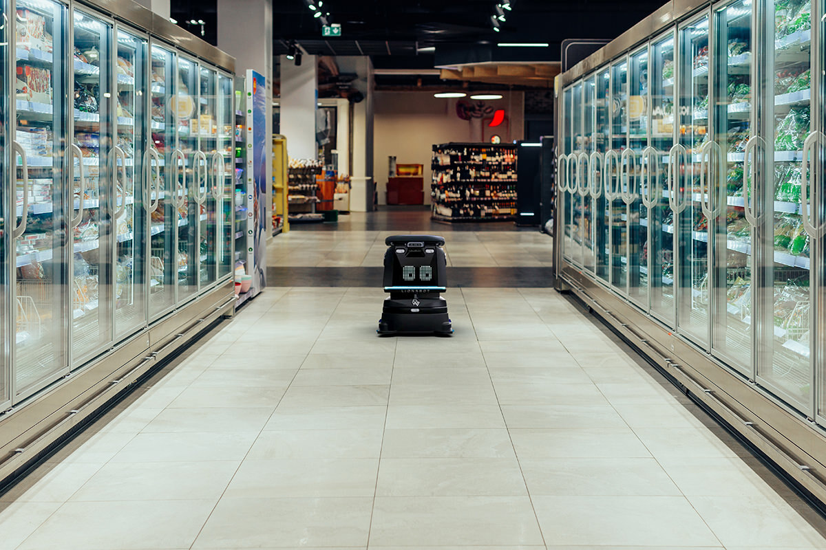 A robotic floor cleaner in a grocery store